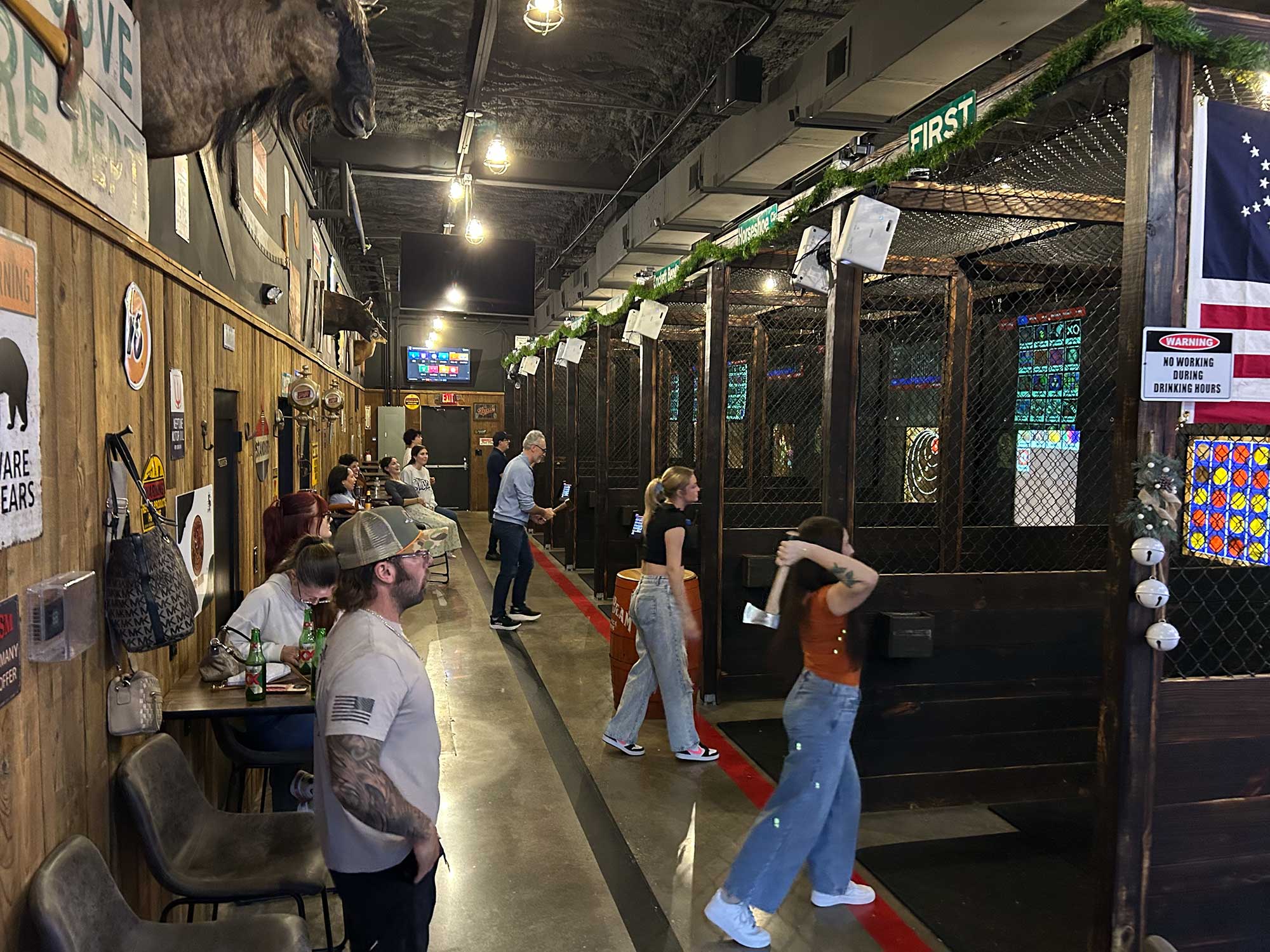 Guests throwing axes in the projected lanes at Axe-Mania in Kingwood, TX during Summer Showdown League night
